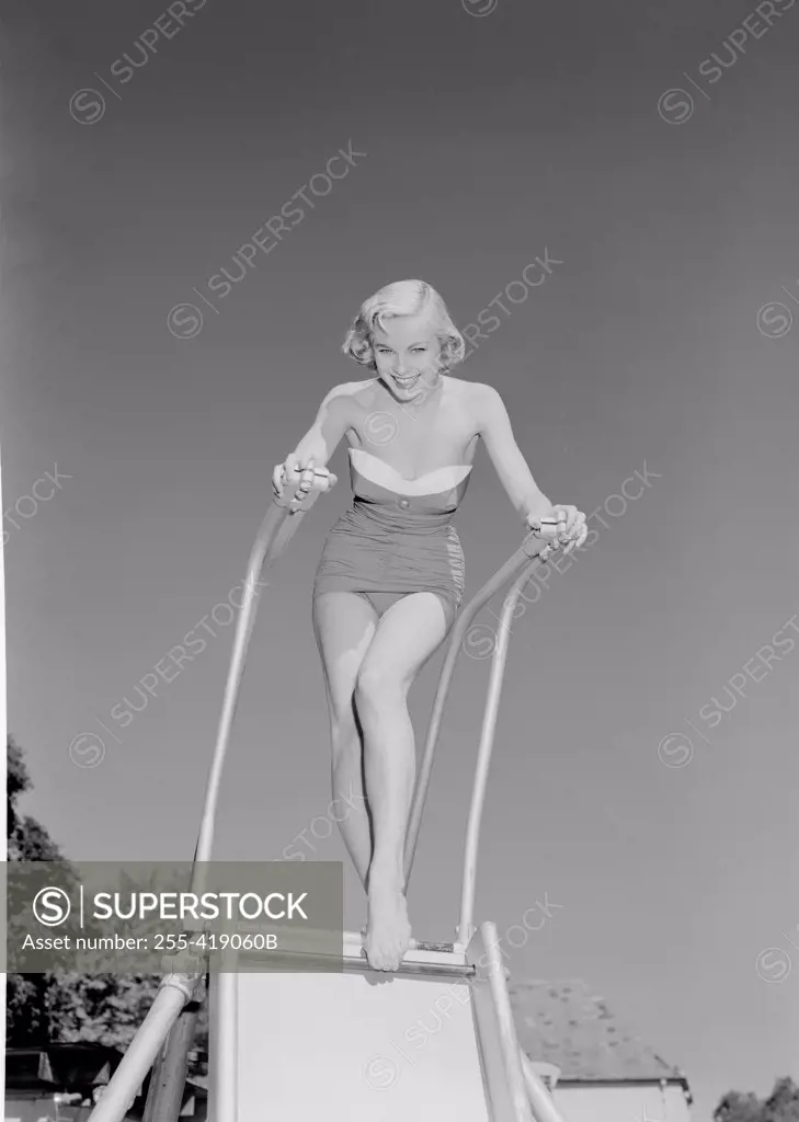 Young woman in swimwear on slide
