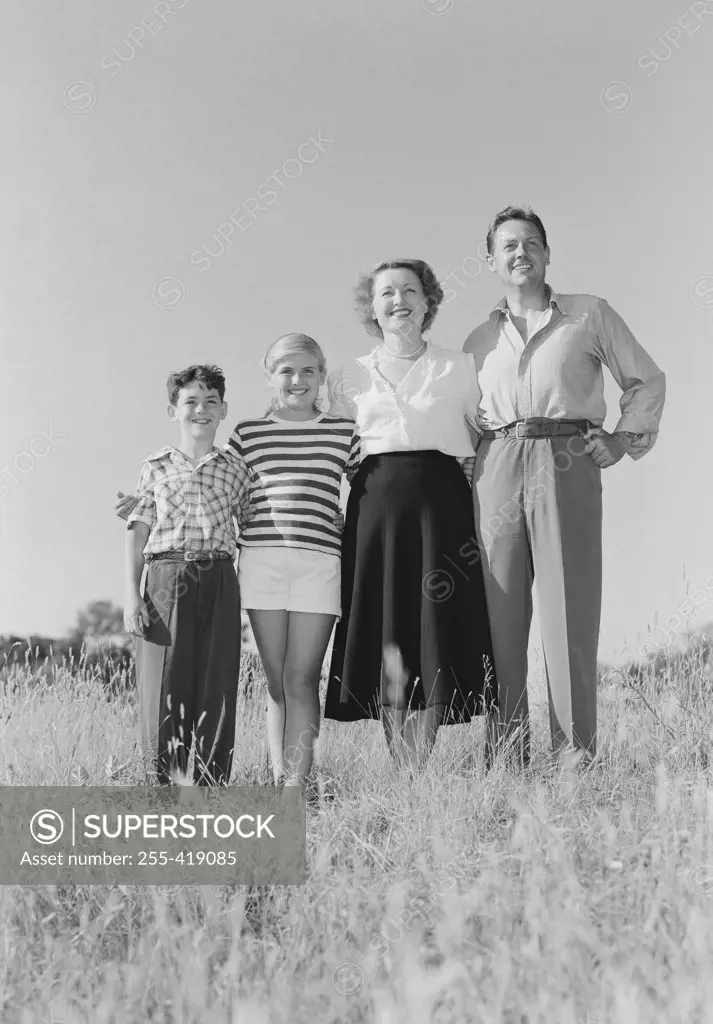Parents with children standing in meadow