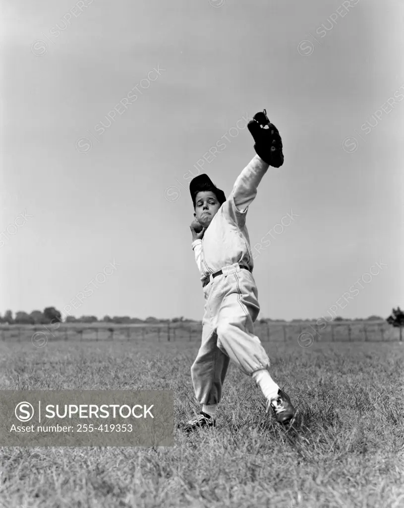 Boy preparing to throw ball inn baseball