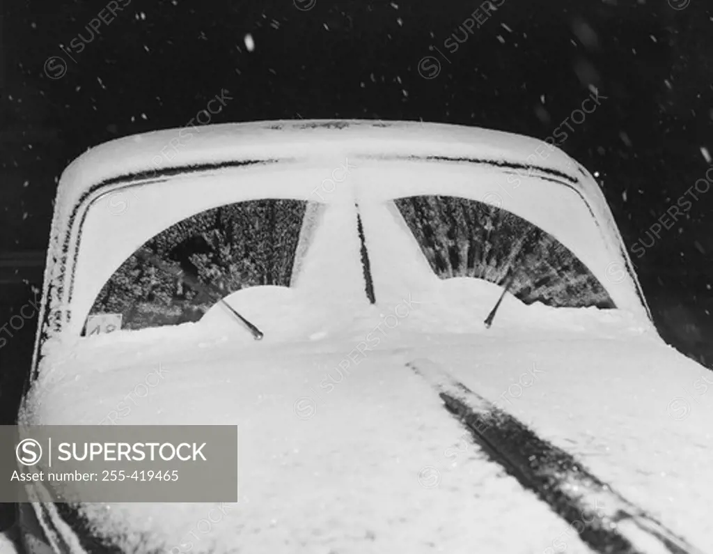 Wind shield wipers in motion clearing snow from wind shield