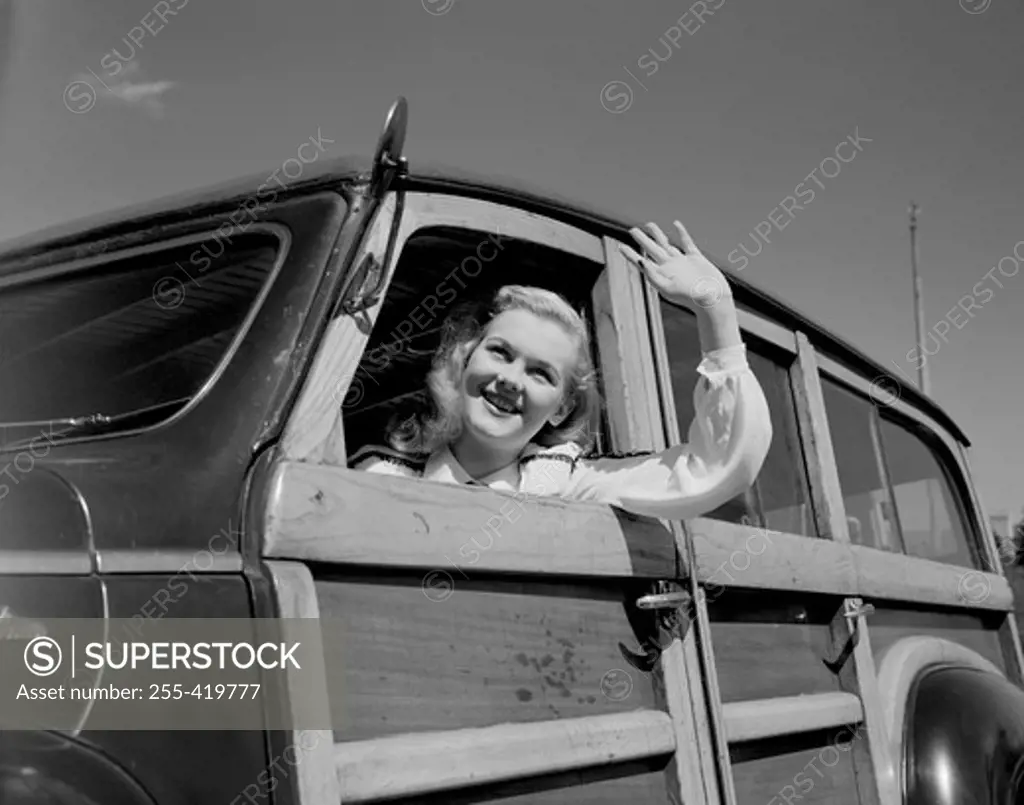 Woman waving from car