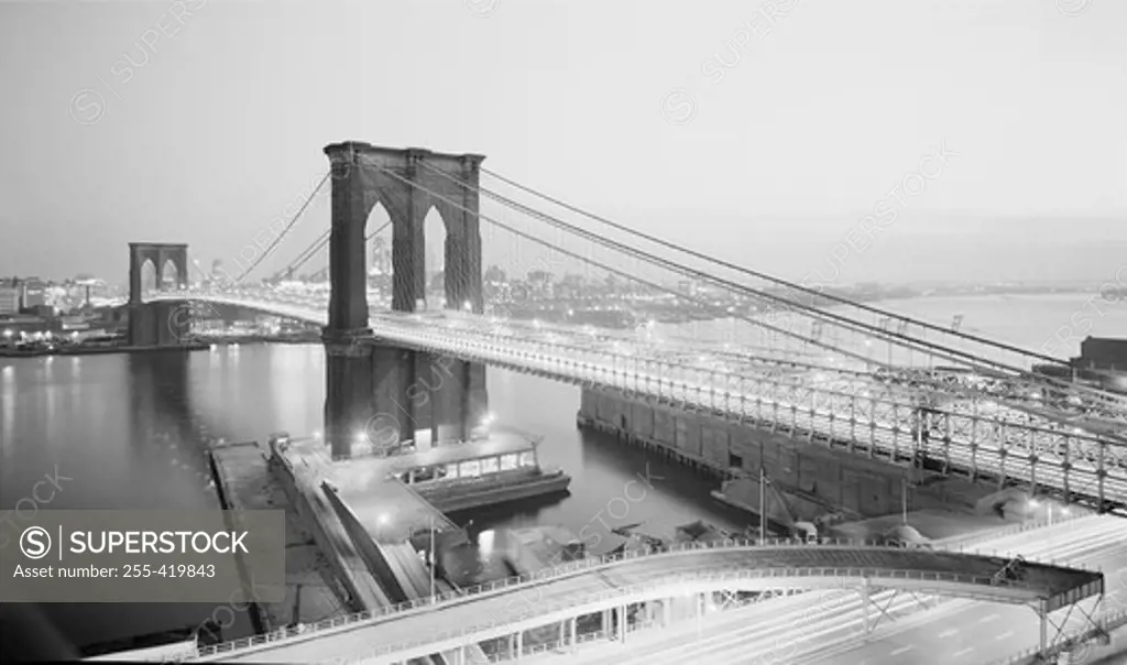 USA, New York State, New York City, Night view of Brooklyn Bridge with Brooklyn in background from Manhattan side
