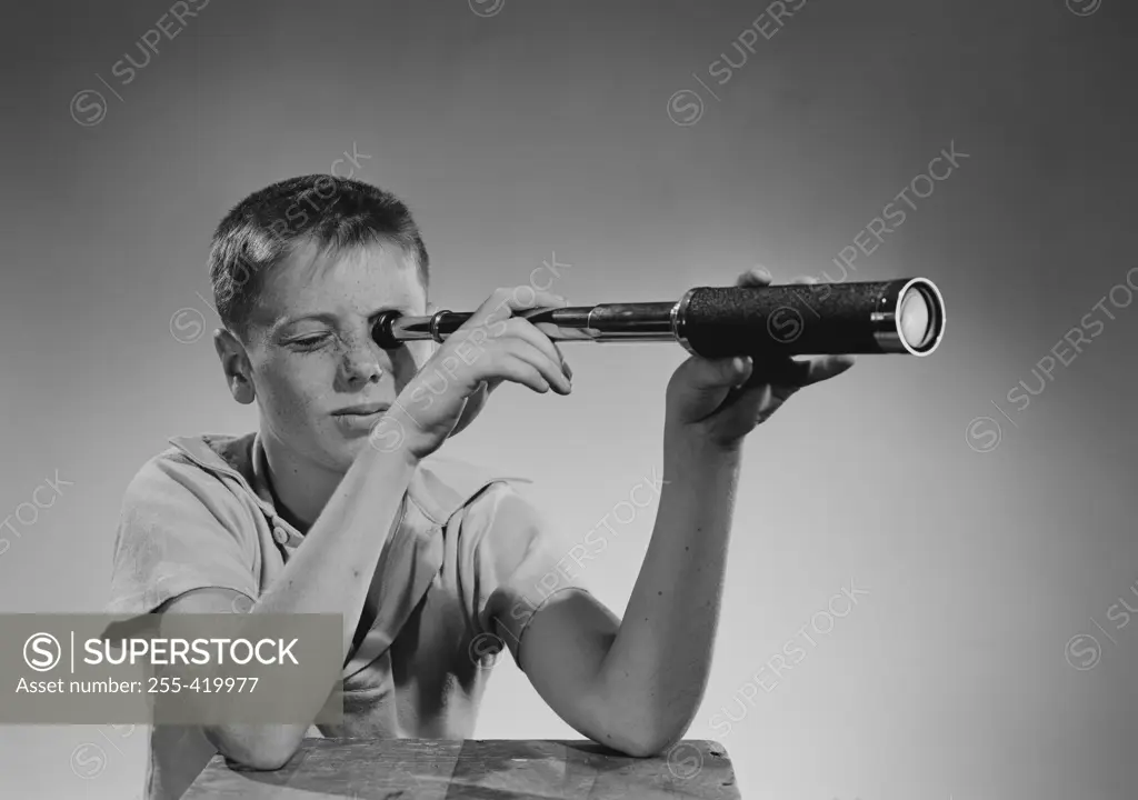 Boy looking through telescope