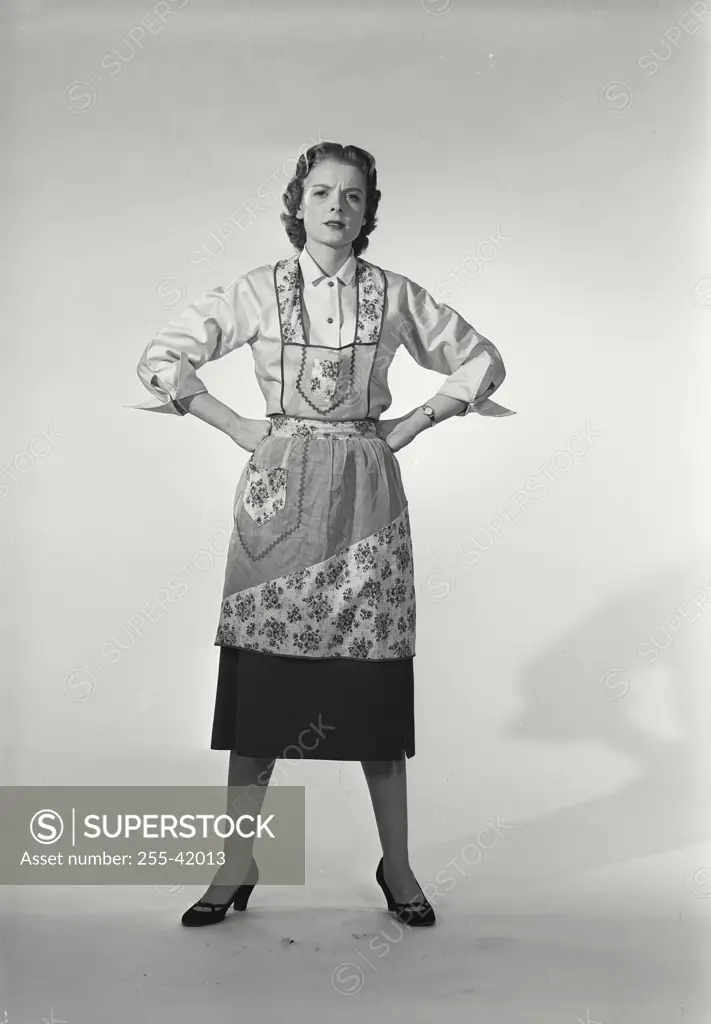 Vintage Photograph. Woman in apron with hands on hips
