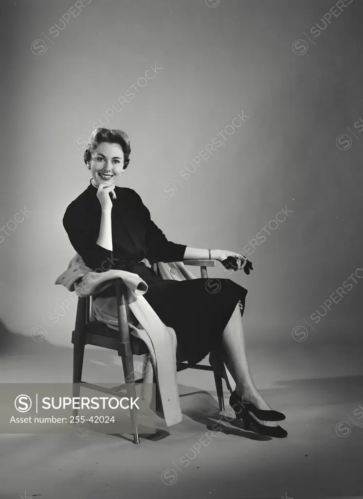 Vintage Photograph. Woman in black dress sitting in wooden chair. Frame 3