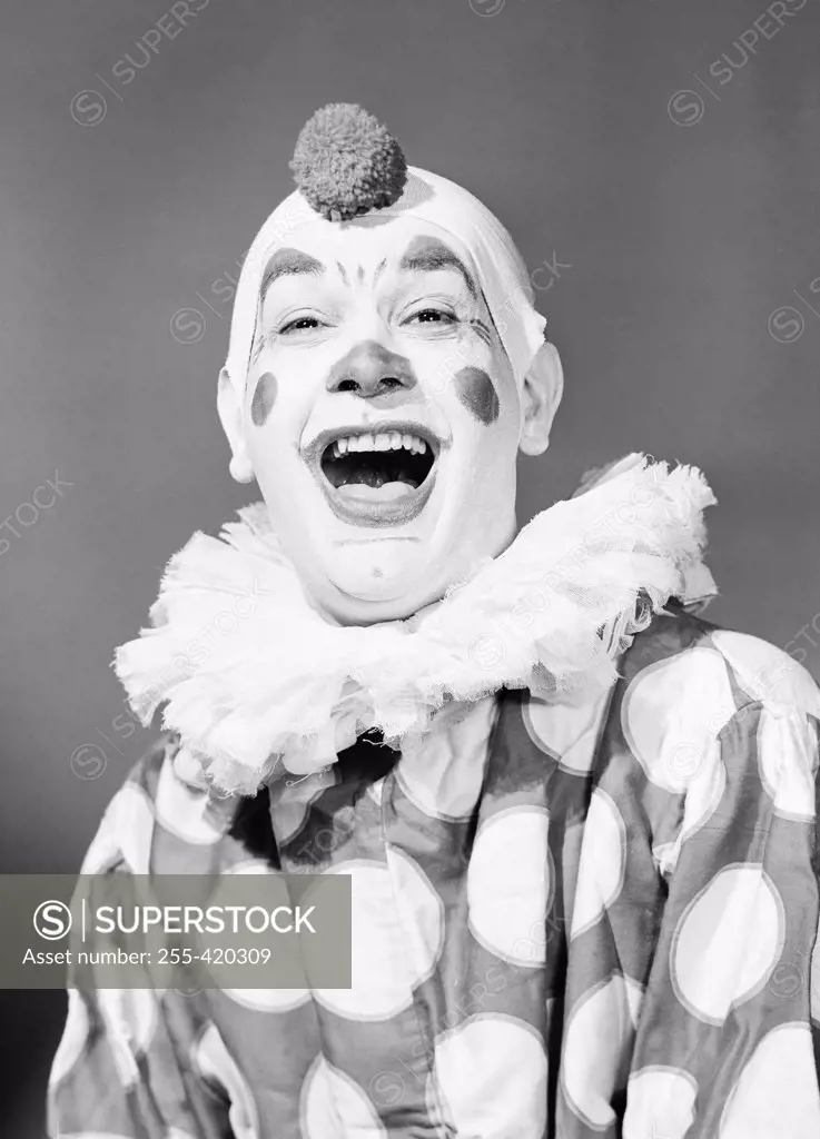 Studio portrait of clown laughing