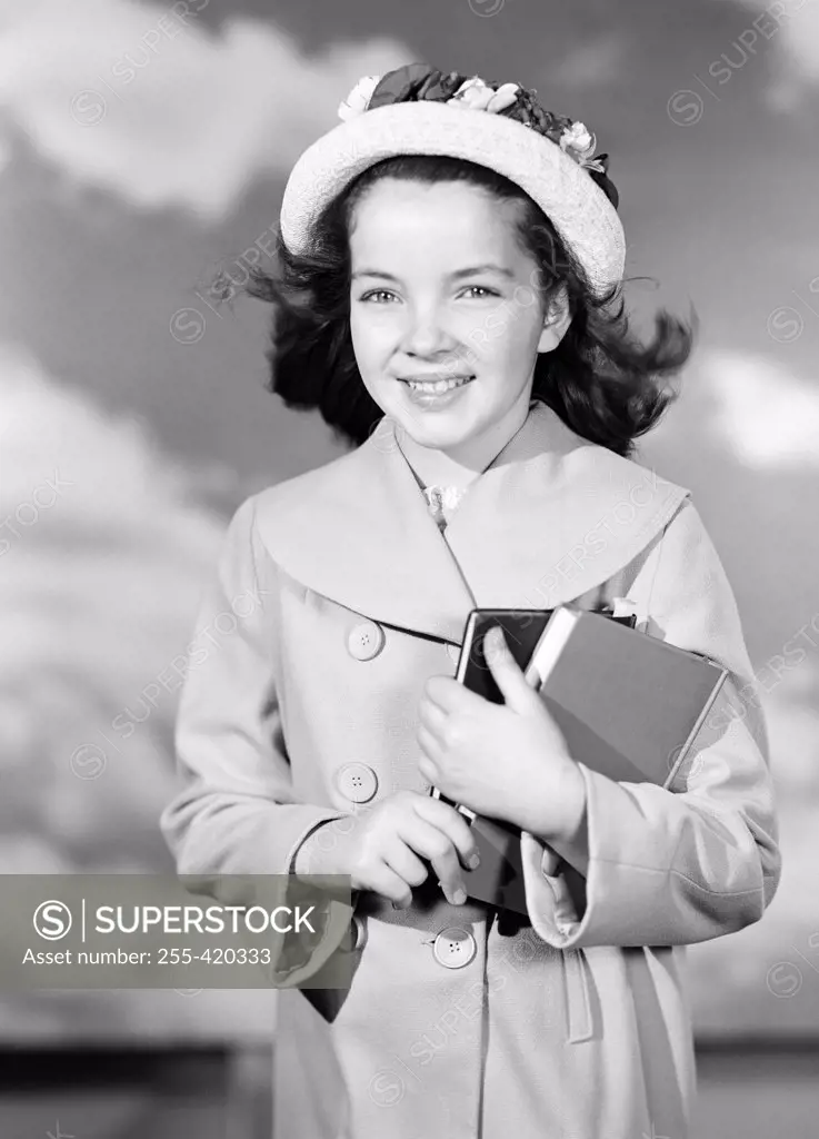 Portrait of school girl holding books