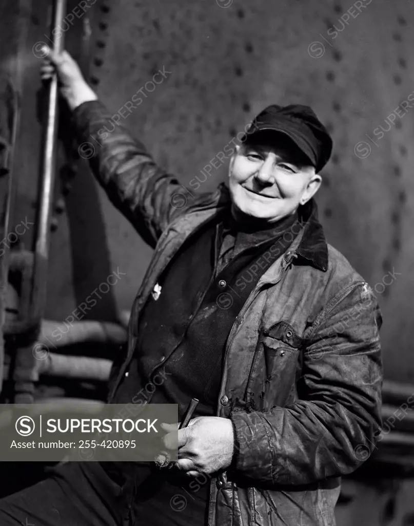 Portrait of man stoking boiler in train