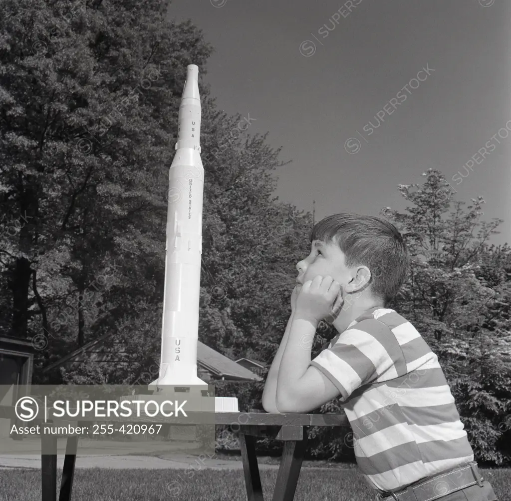 Boy playing with toy rocket