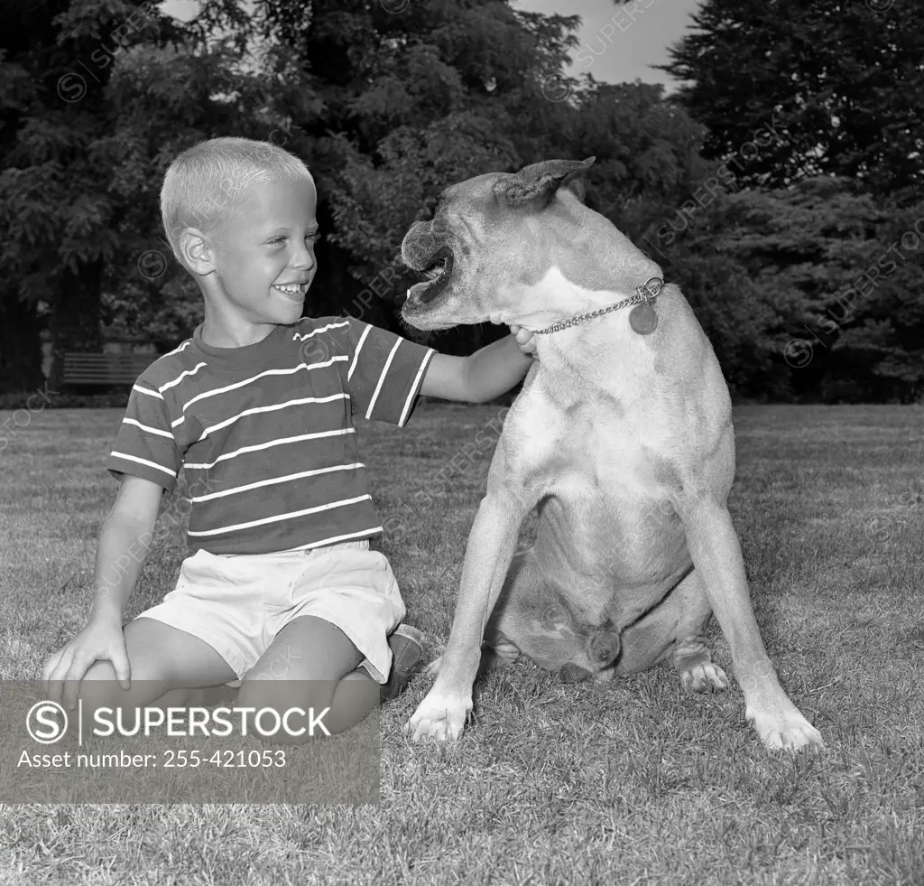 Portrait of boy with boxer dog