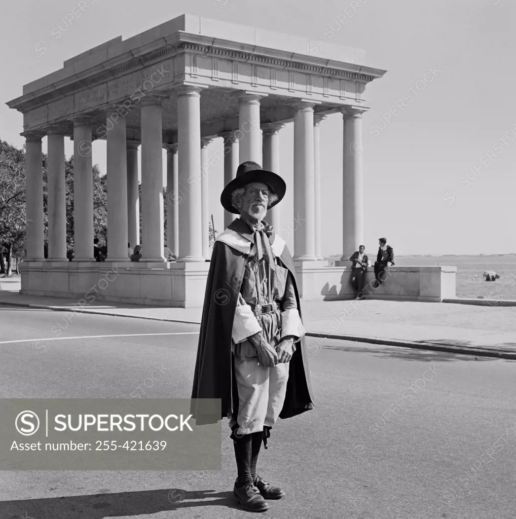 USA, Massachusetts, Plymouth, Plymouth Rock showing attendant dressed as Pilgrim Father for atmosphere