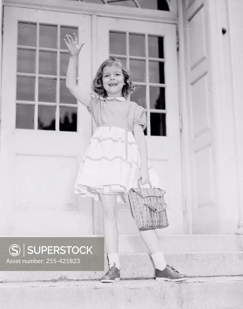 Girl waving from porch