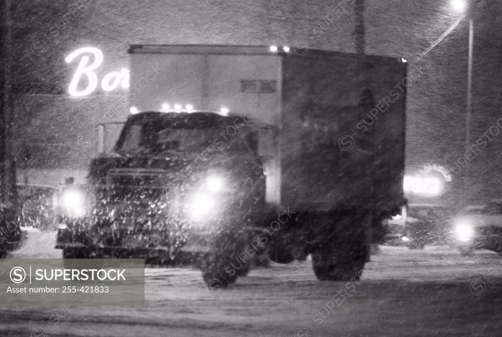 Truck in blizzard at night
