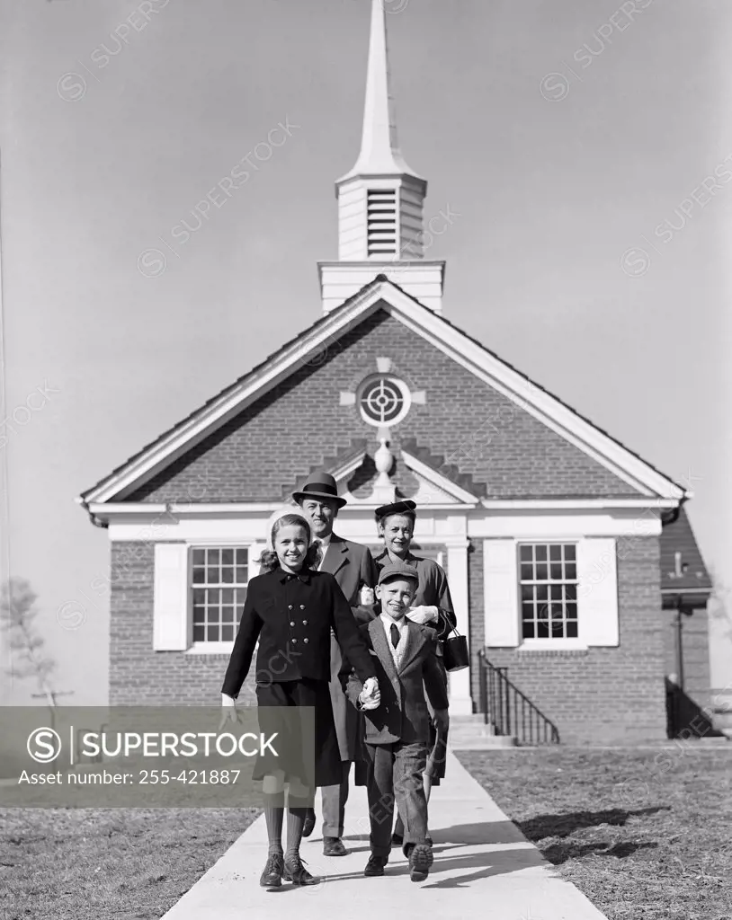 Parents with children in front of church