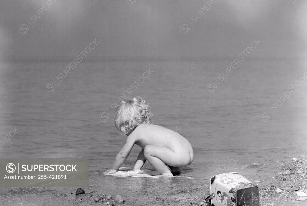 Girl playing on lake shore