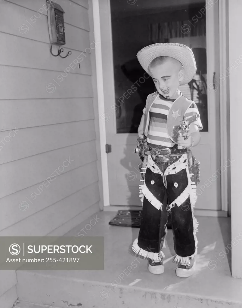 Boy wearing cowboy costume