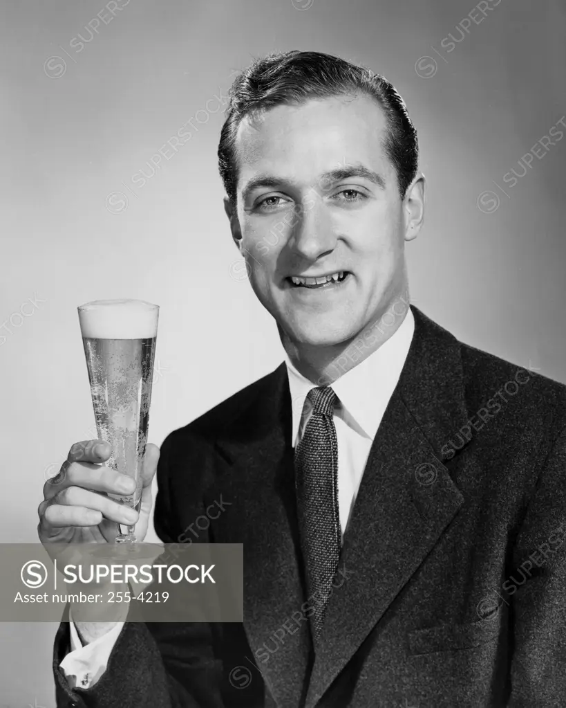 Portrait of a mid adult man holding a glass of beer