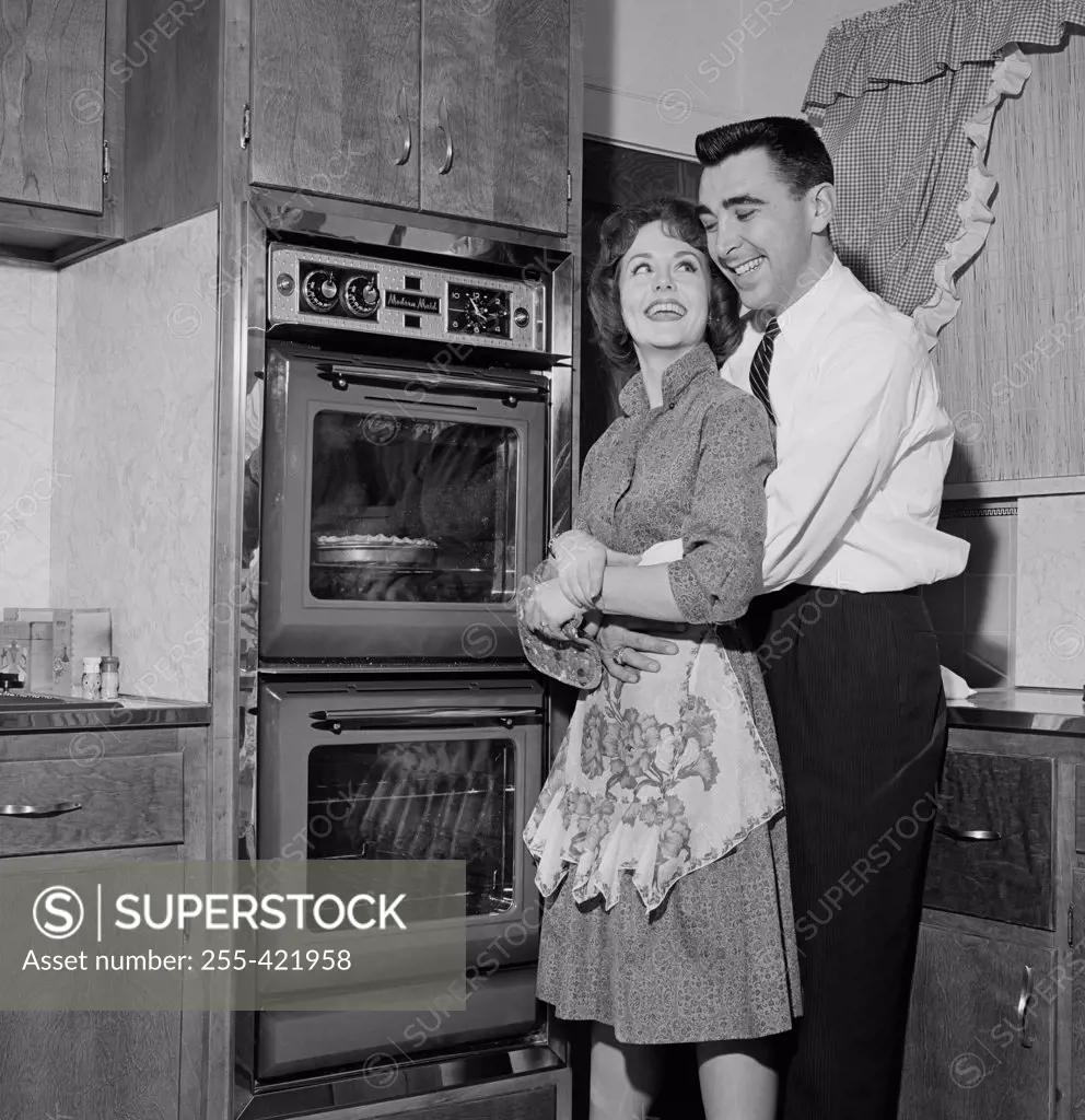 Happy couple in domestic kitchen