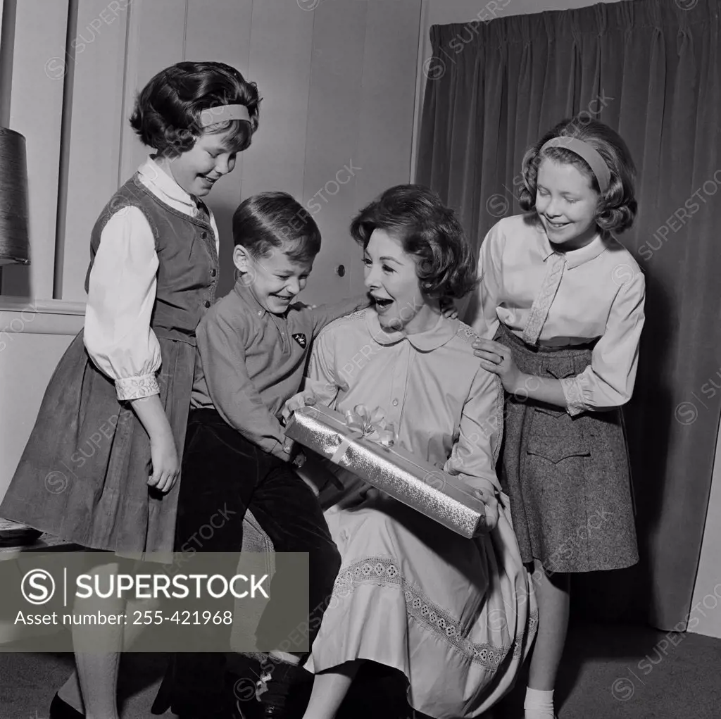 Woman celebrating birthday with daughters and son