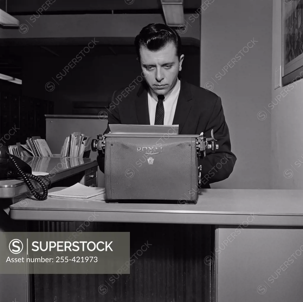 Businessman typing in office environment