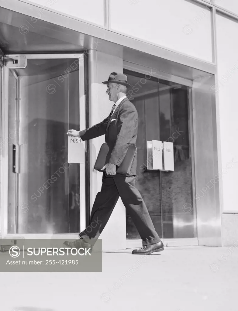 Senior businessman entering office building