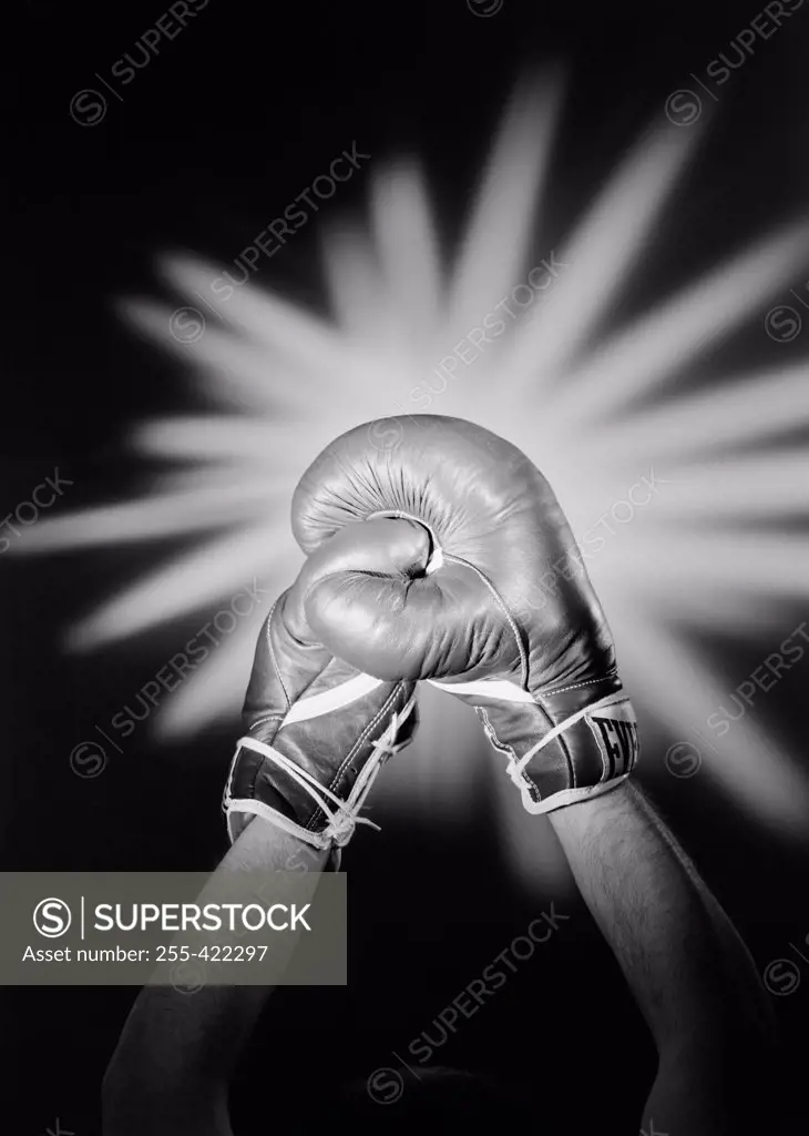 Hands wearing boxing gloves celebrating victory