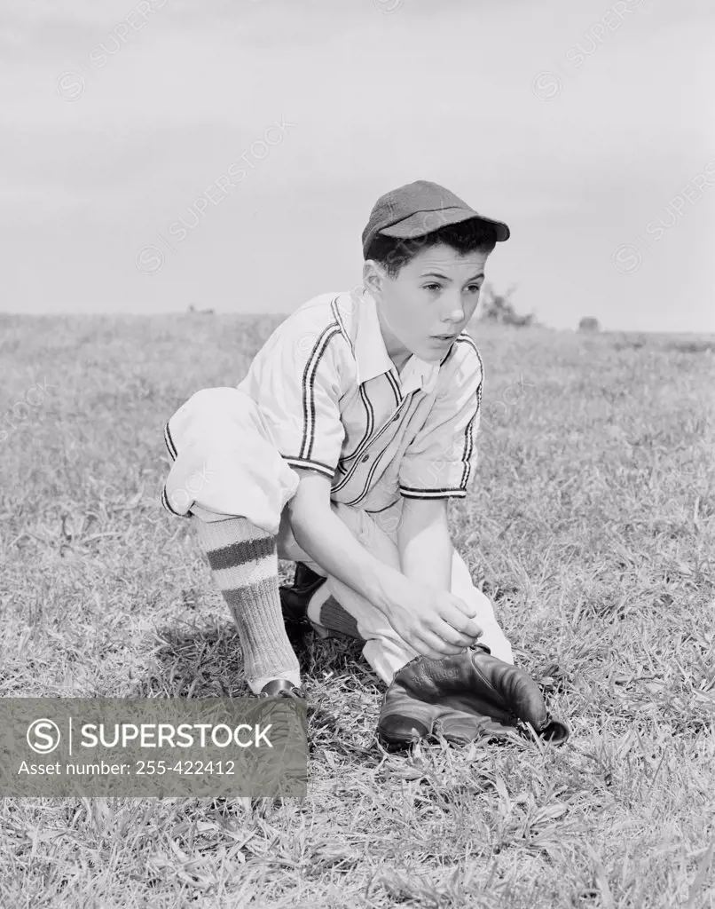 Boy putting on baseball glove