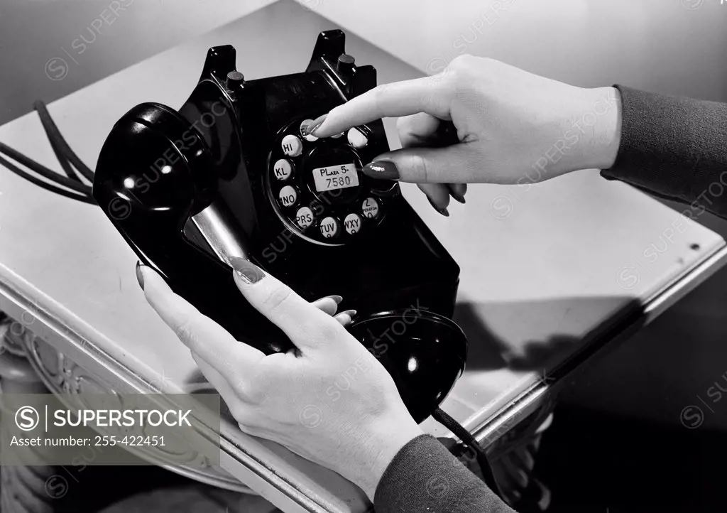 Woman holding vintage telephone