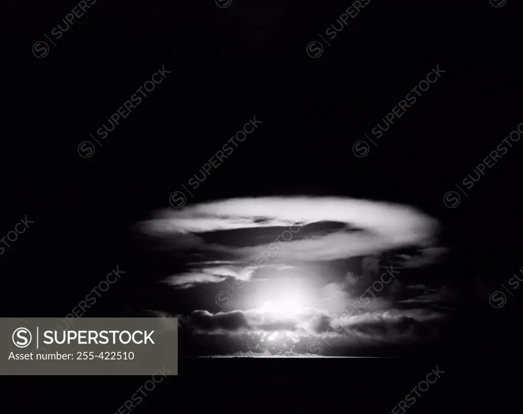 Pacific Ocean, Eniwetok Atoll, Fire ball of nuclear detonation rises through clouds during tests in 1951