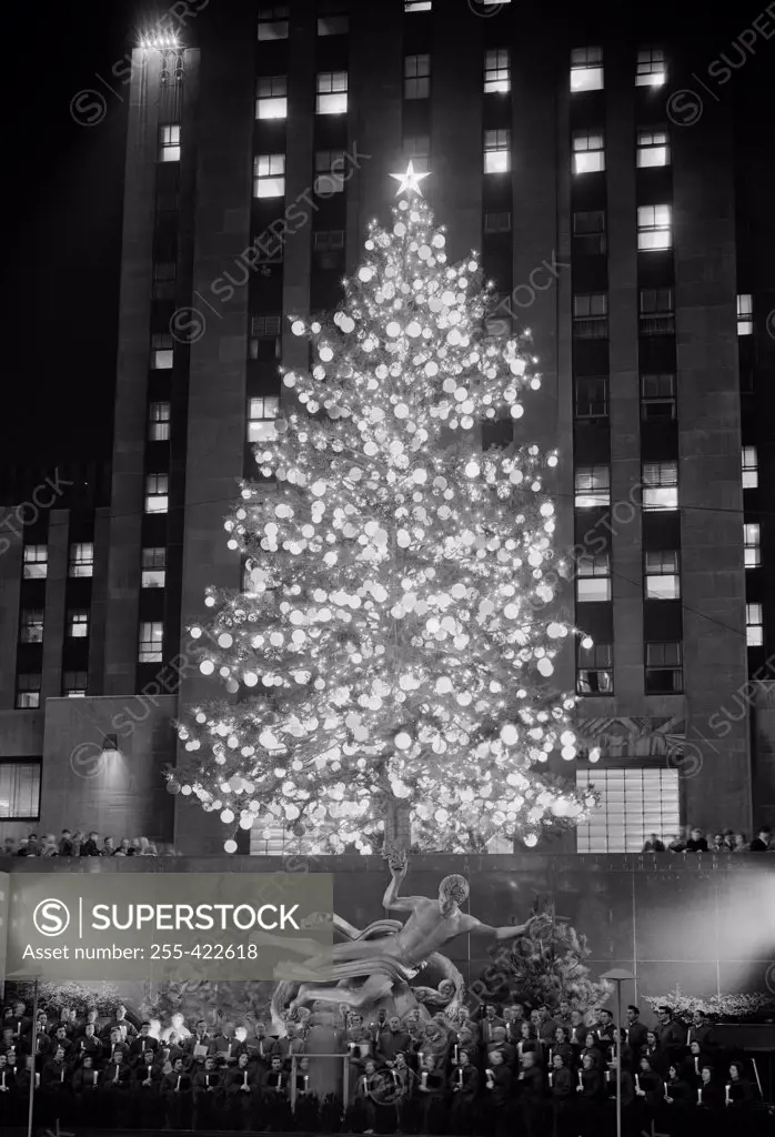 USA, New York State, New York City, Rockefeller Center, Christmas tree at Radio City with Choral group singing, 1956