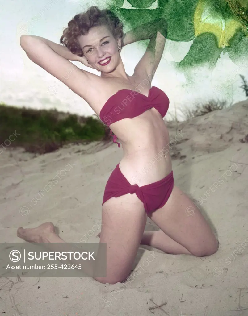 Young woman in bikini posing on beach