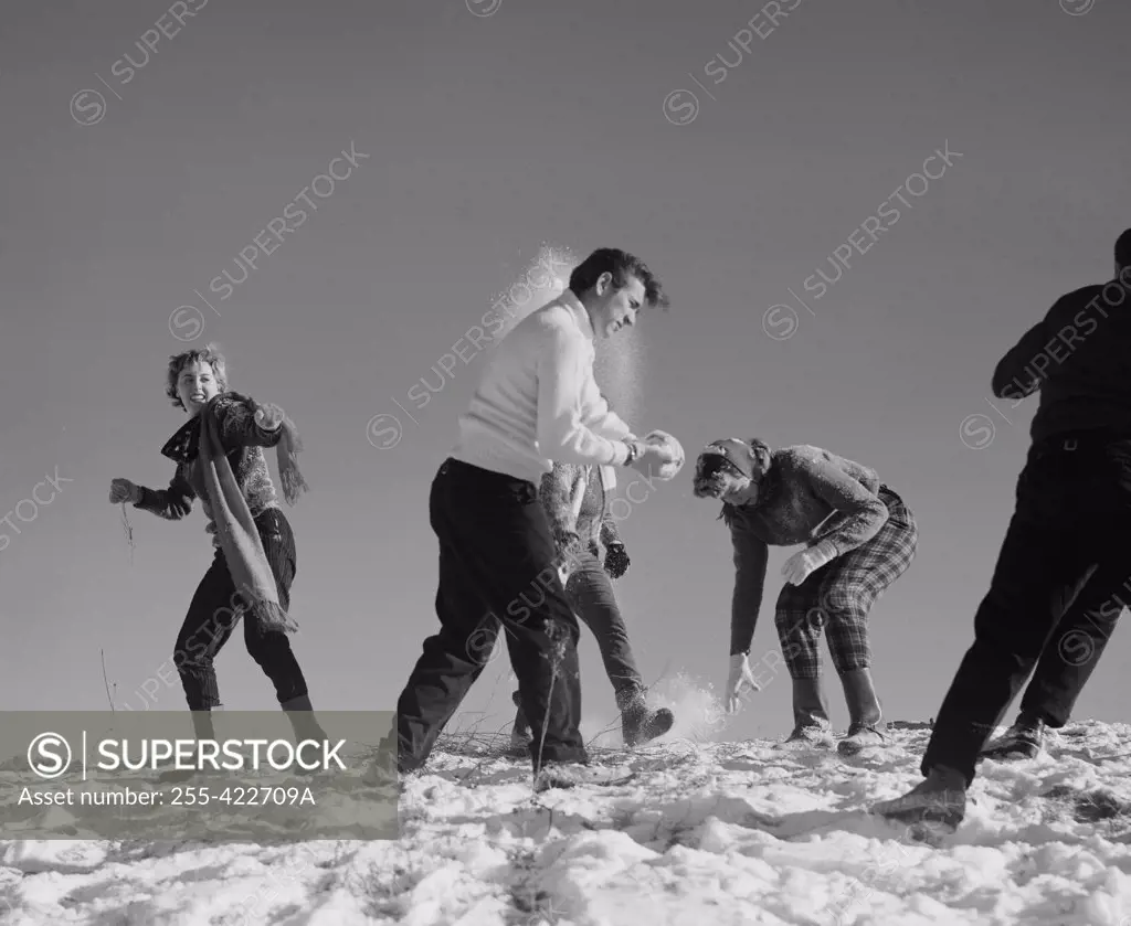 Young people playing with snow