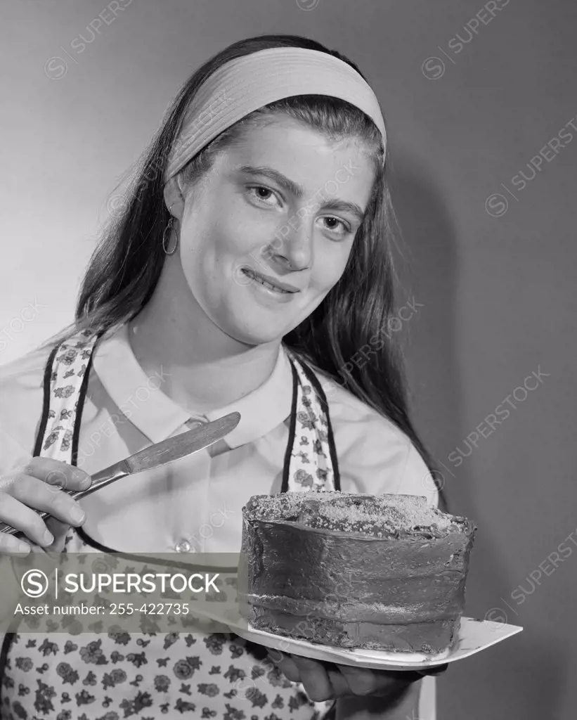 Portrait of young woman holding cake