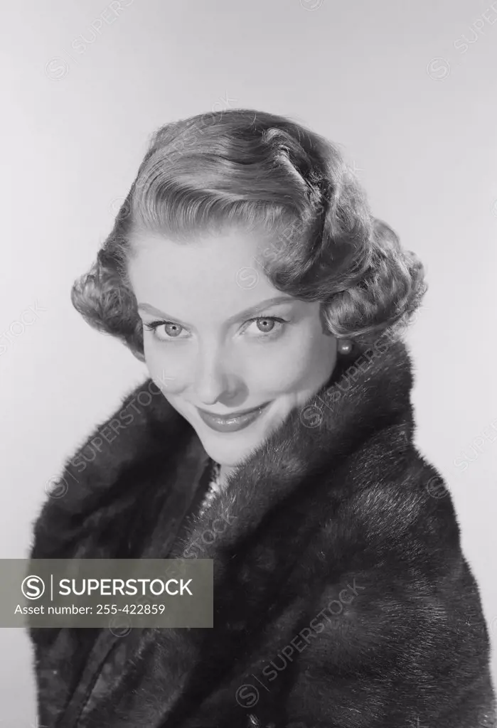 Studio portrait of young woman smiling