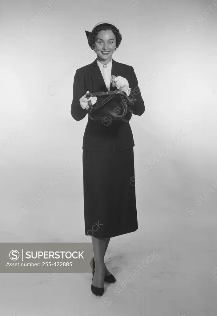  Studio Portrait of a mid adult woman holding purse.