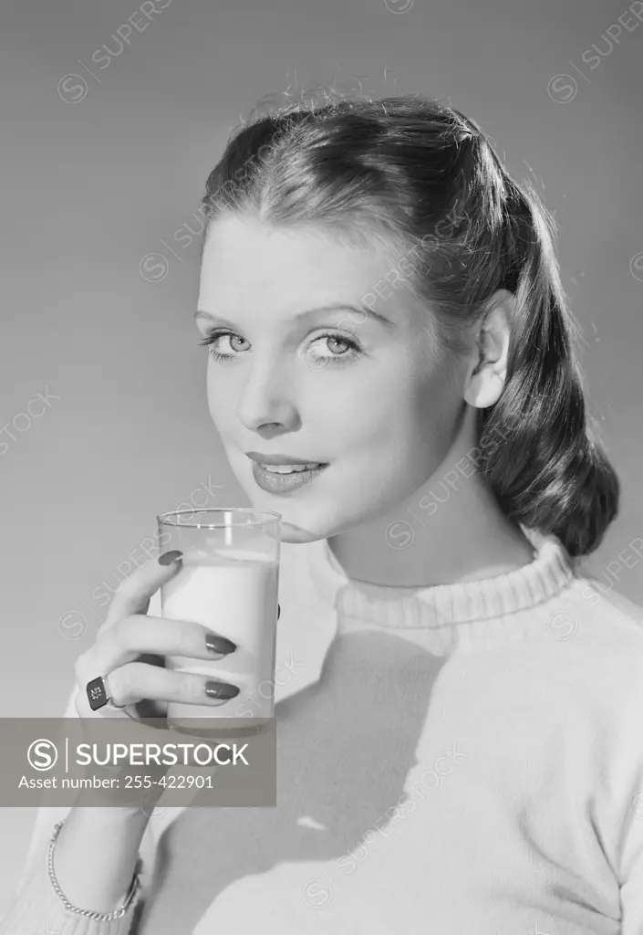 Young woman holding glass of milk