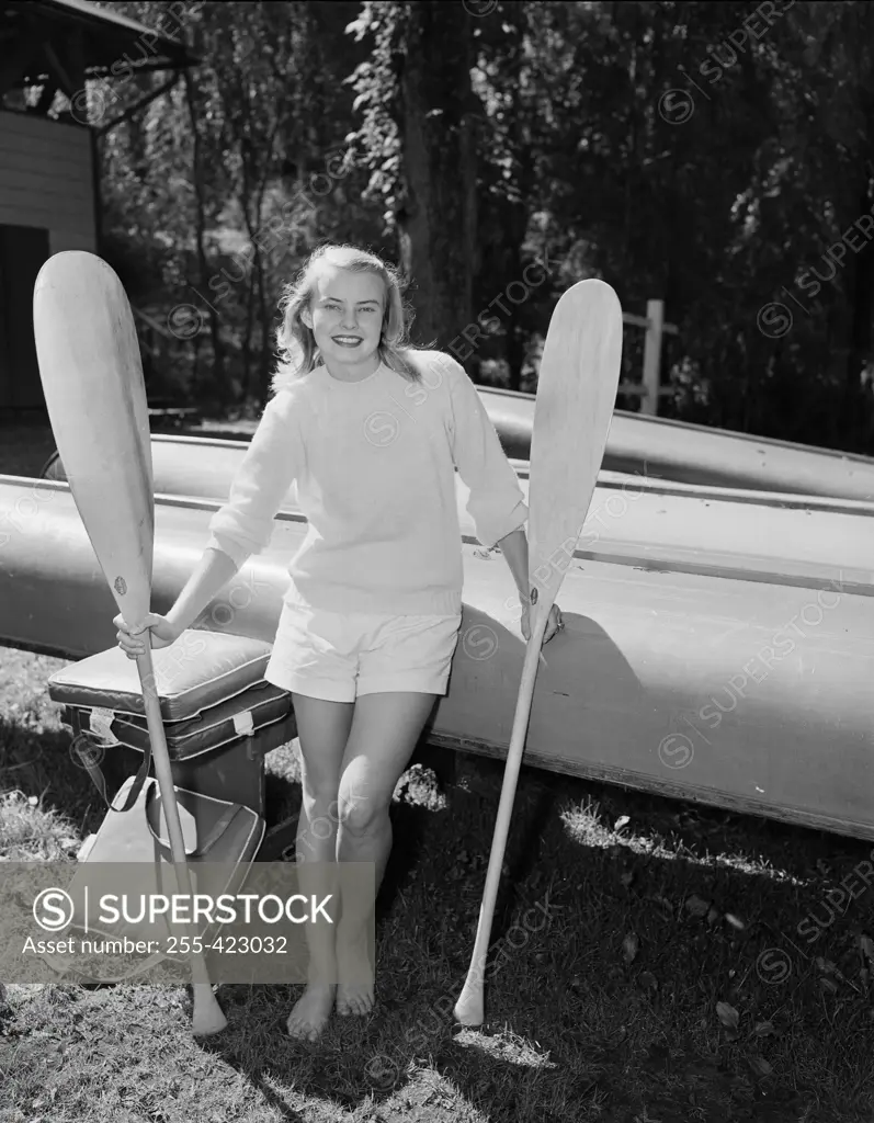 Young attractive woman posing with paddles
