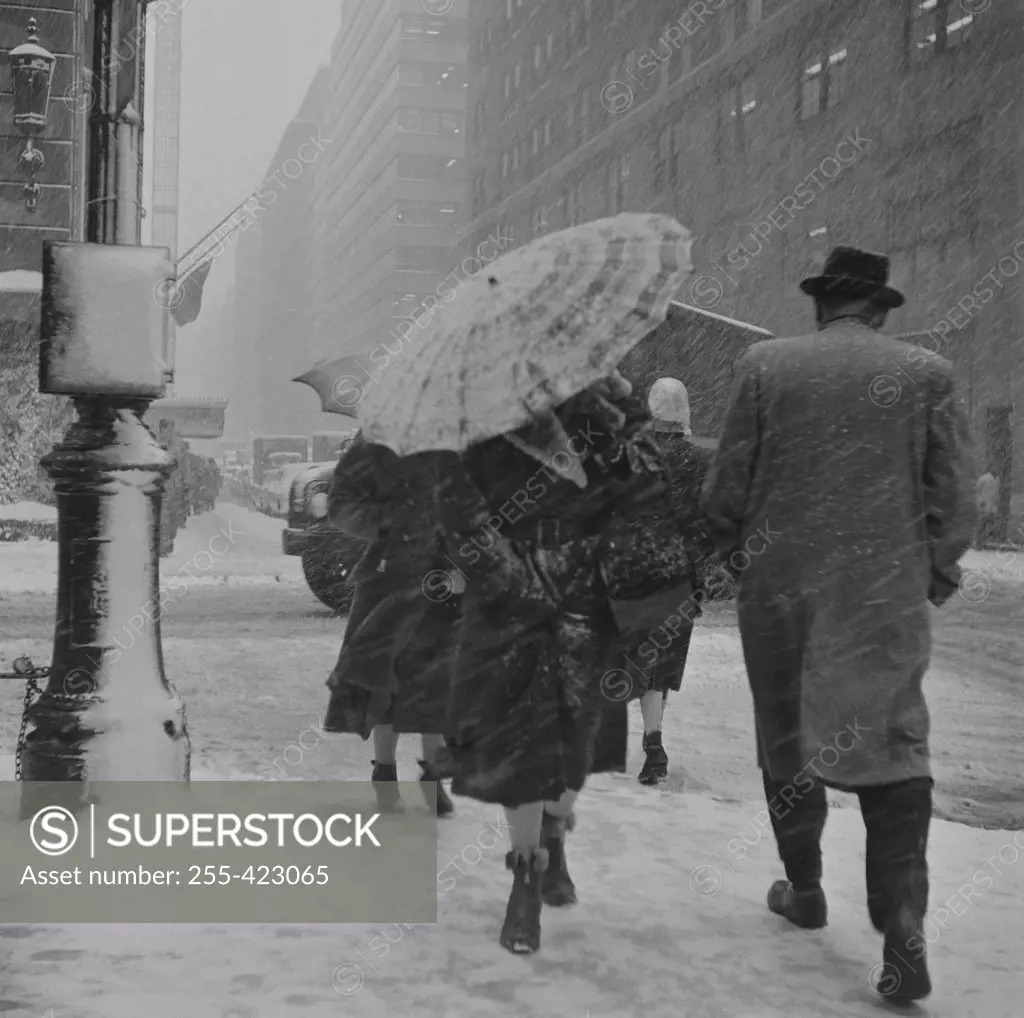 USA, New York City, People walking in snowstorm