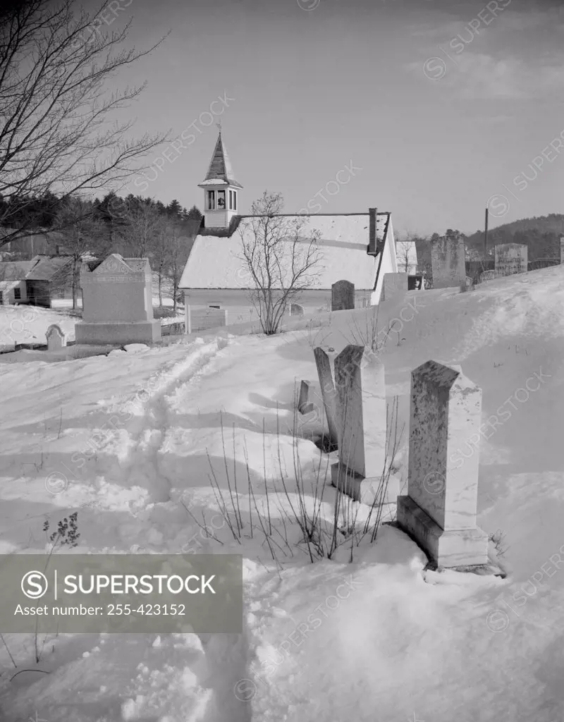 USA, Vermont, church and graveyard in snow