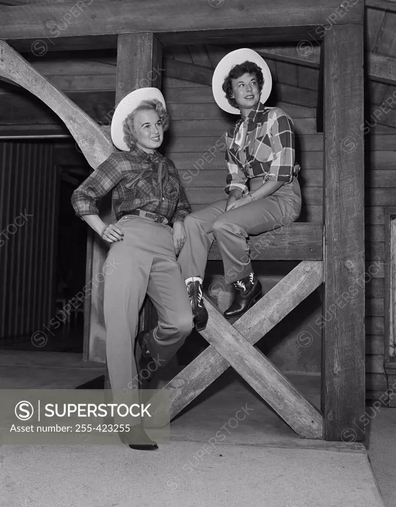 USA, Colorado, Evergreen, Dude Ranch, Lazy Valley Inn, Two cowgirls on porch