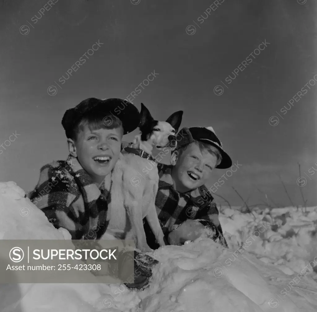 Twin boys with pet dog