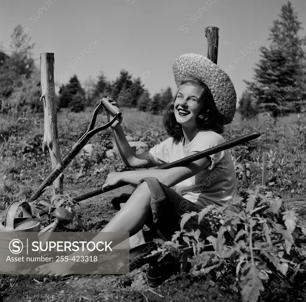 Young woman resting in farm field