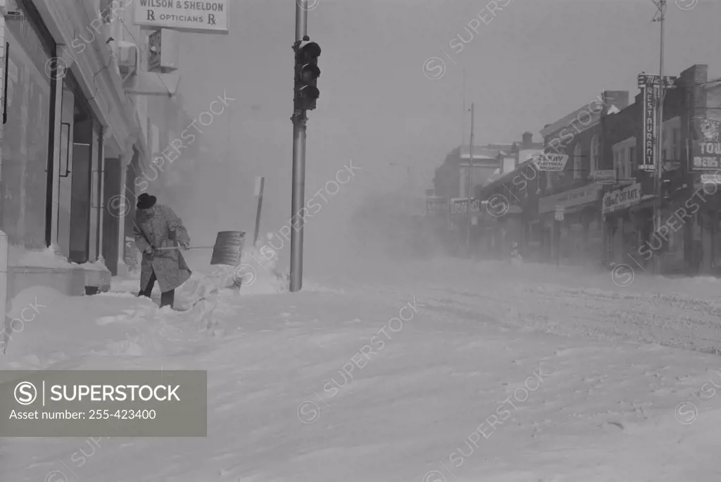 USA, Pennsylvania, Man digging snow from street