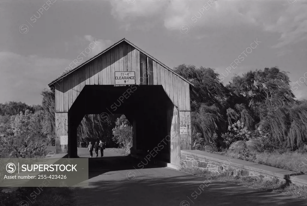 USA, Pennsylvania, People walking under covered bridge