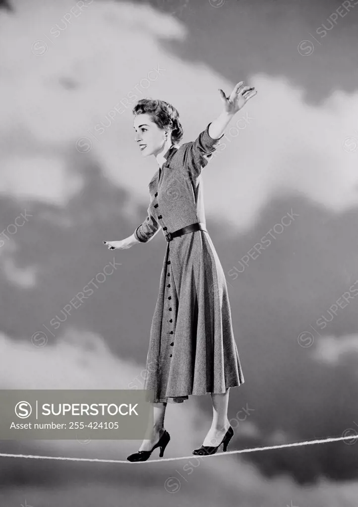 Young woman walking on tight rope