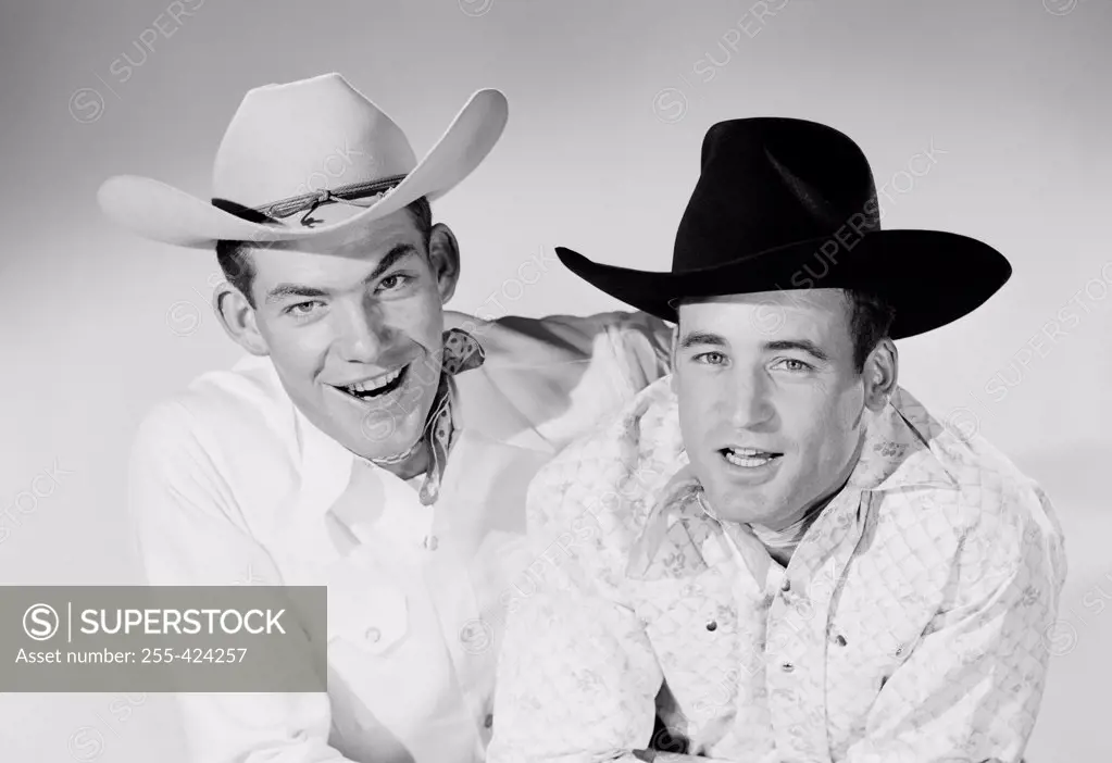 Portrait of cheerful cowboys