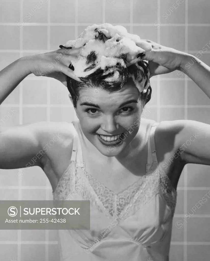 Young woman shampooing her hair