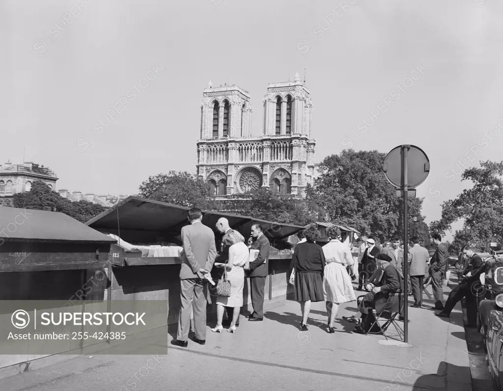 France, Paris, Book stalls along Seine, Notre Dame Cathedral in background