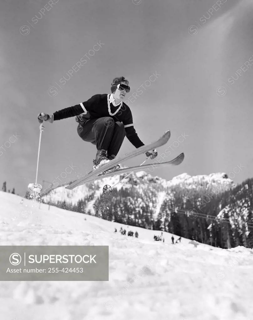 Skier jumping over slope