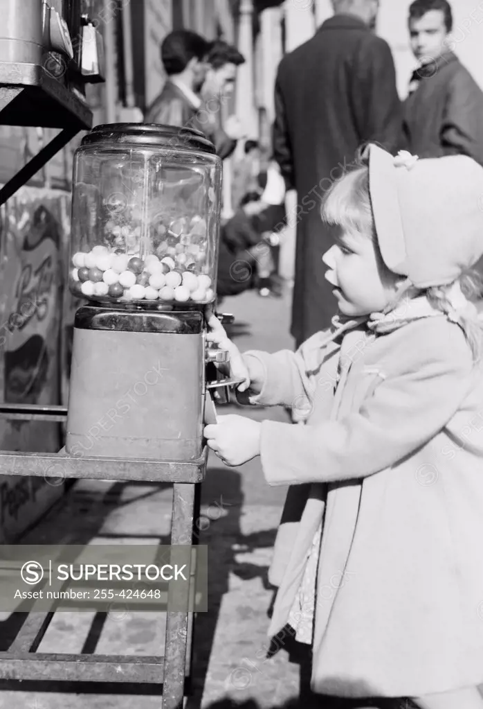 Little girl at Penny Ball gum machine